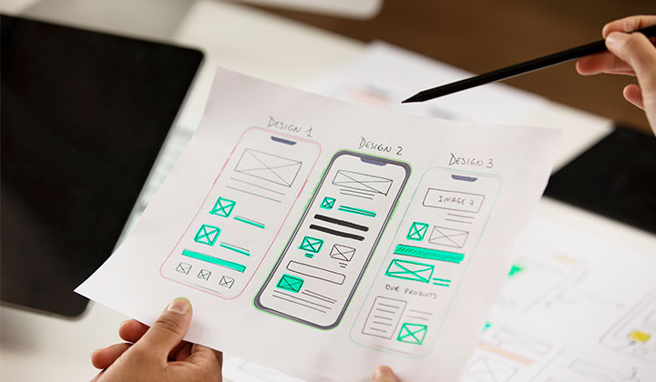 Paper mockup of the UX design used in software development solutions.